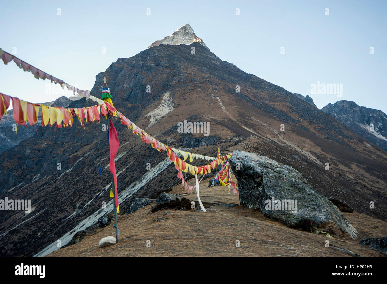 Prayer flags on a mountain ridge, Himalayas, Nepal Stock Photo