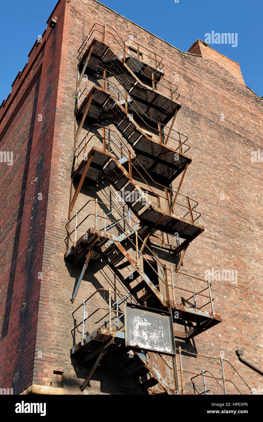 old metal fire escape on side of red brick warehouse building liverpool docks uk Stock Photo