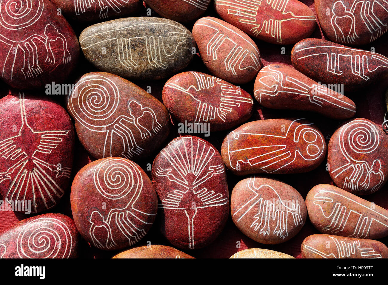 Southern America, Nazca Lines drawn on stones which are being sold in the tourist as souvenirs from Peru Stock Photo