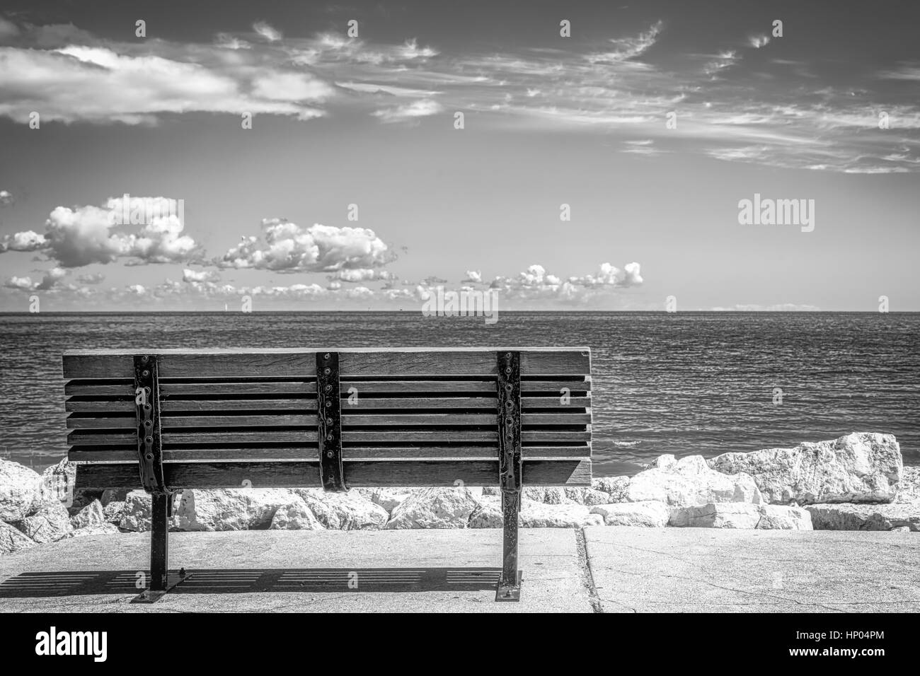 A park bench overlooking Green Bay from Bay Beach Park (Green Bay, Wisconsin) Stock Photo