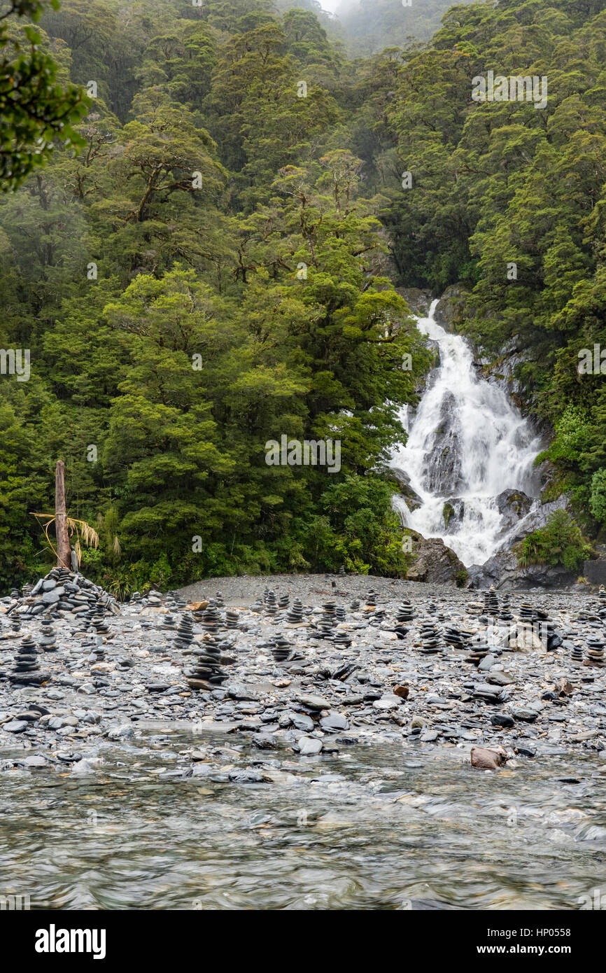 Fantail Falls and pebble stacks off the Haast Highway, Mount Aspiring National Park, South Island, New Zealand Stock Photo