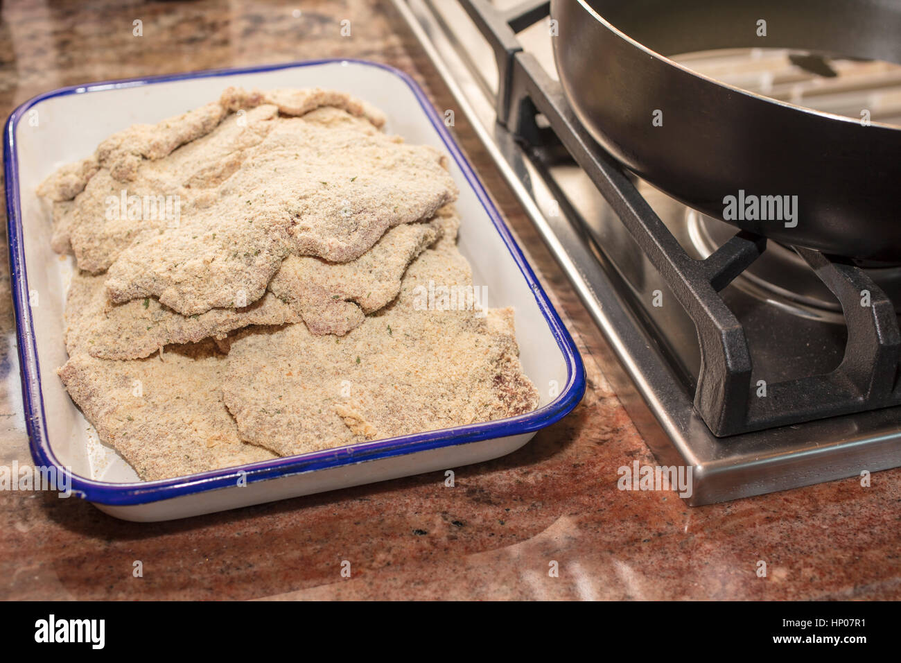 Breaded steaks ready to fry in oil for a dinner meal Stock Photo Alamy