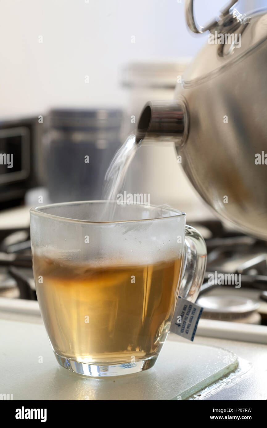 Sequence of pouring water into a glass mug while brewing hot tea Stock ...