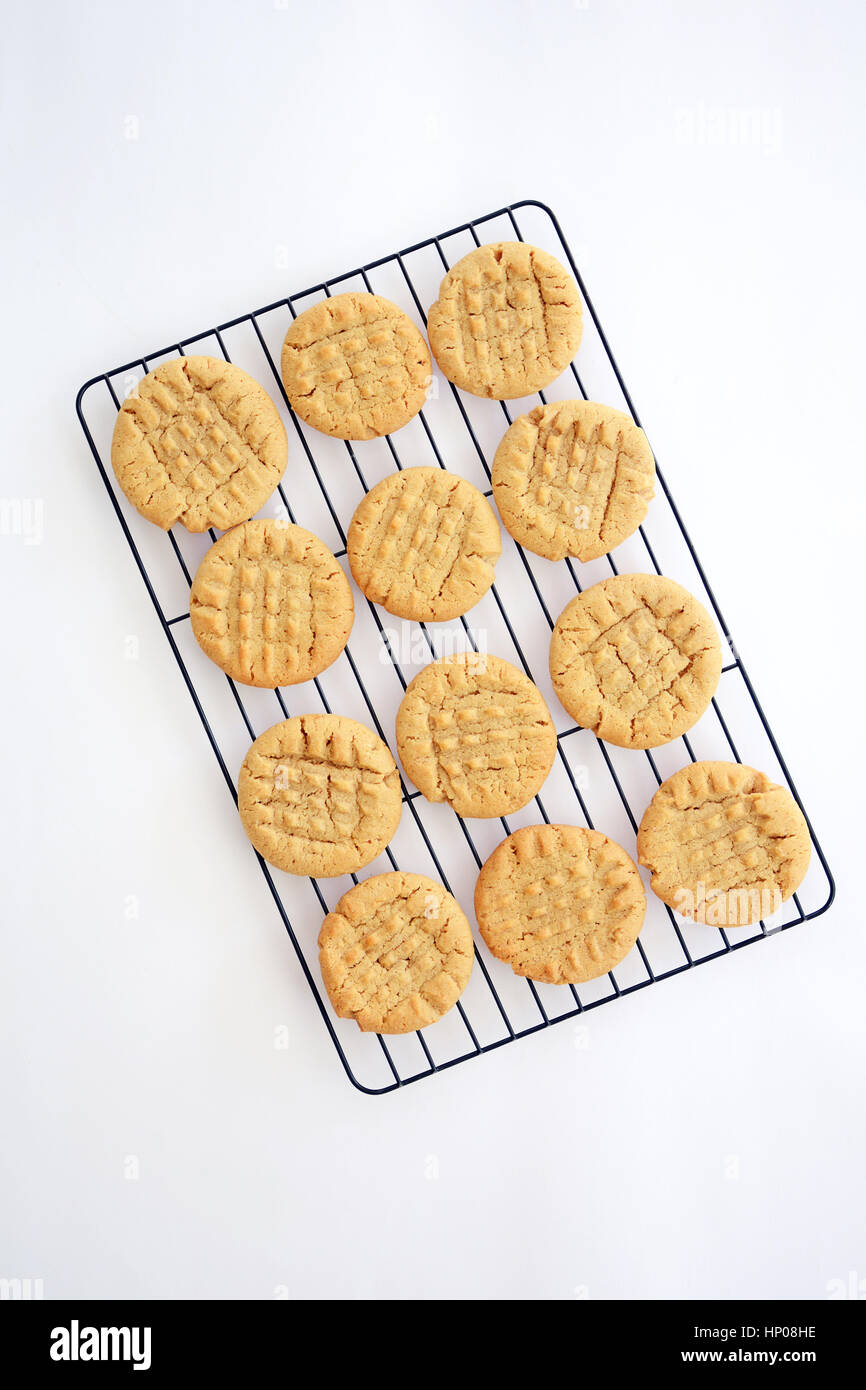 Fresh baked peanut butter cookies cooling on black rack shot from overhead in natural light Stock Photo
