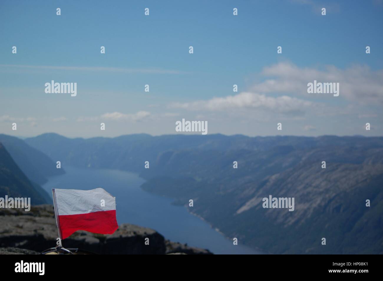 A Polish flag proudly sitting at the top of Lysefjord in Norway. Stock Photo