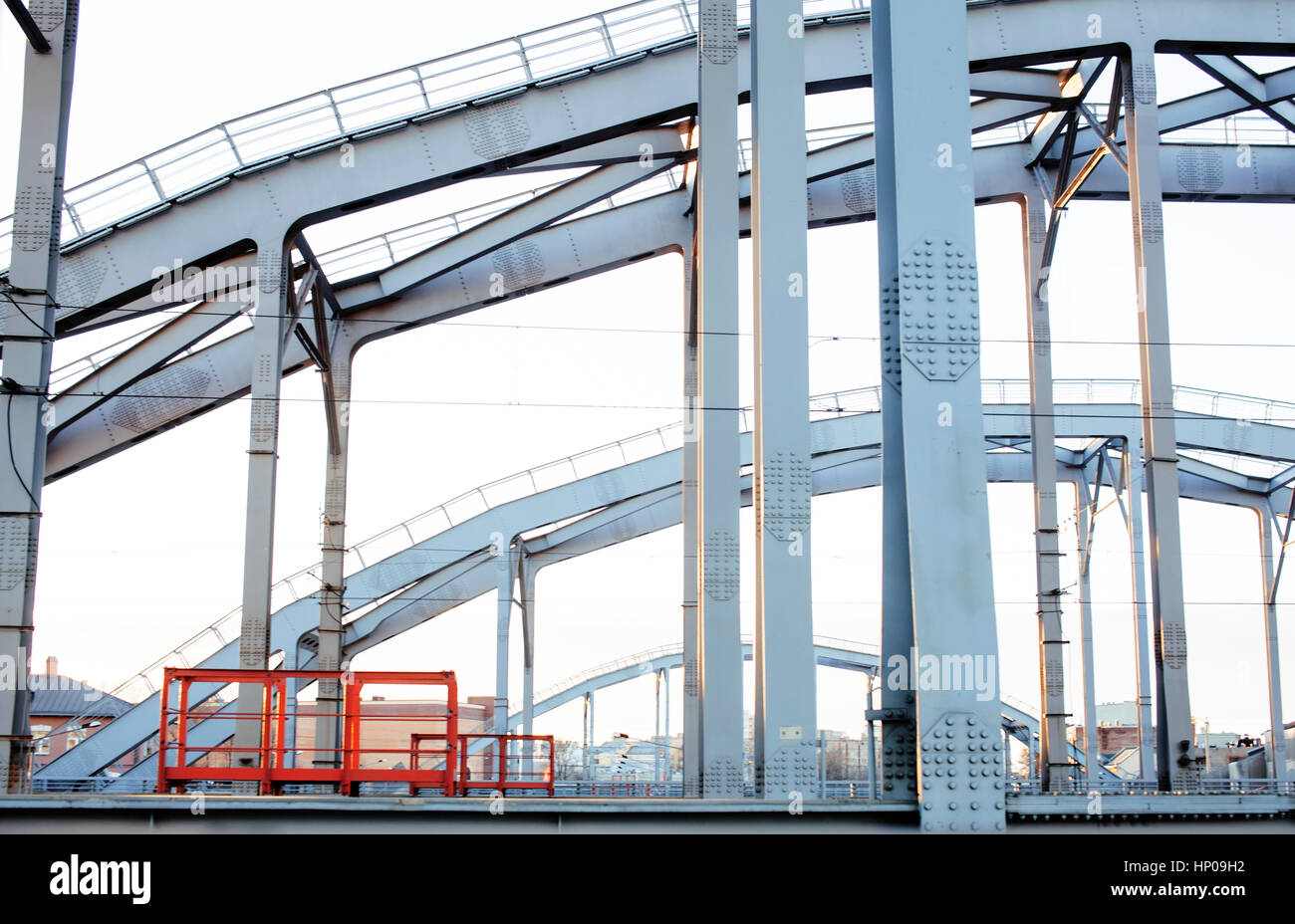 landscape with railway with trains, lot of steel rafters at sunset ...
