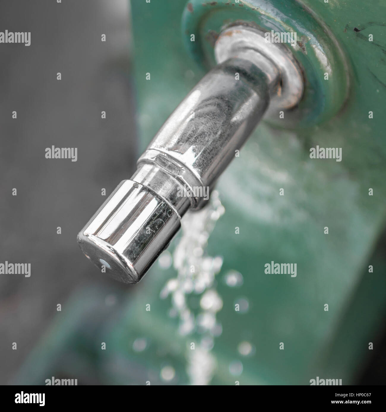 Water fountain in a public garden. Extreme closeup. Top view. Stock Photo