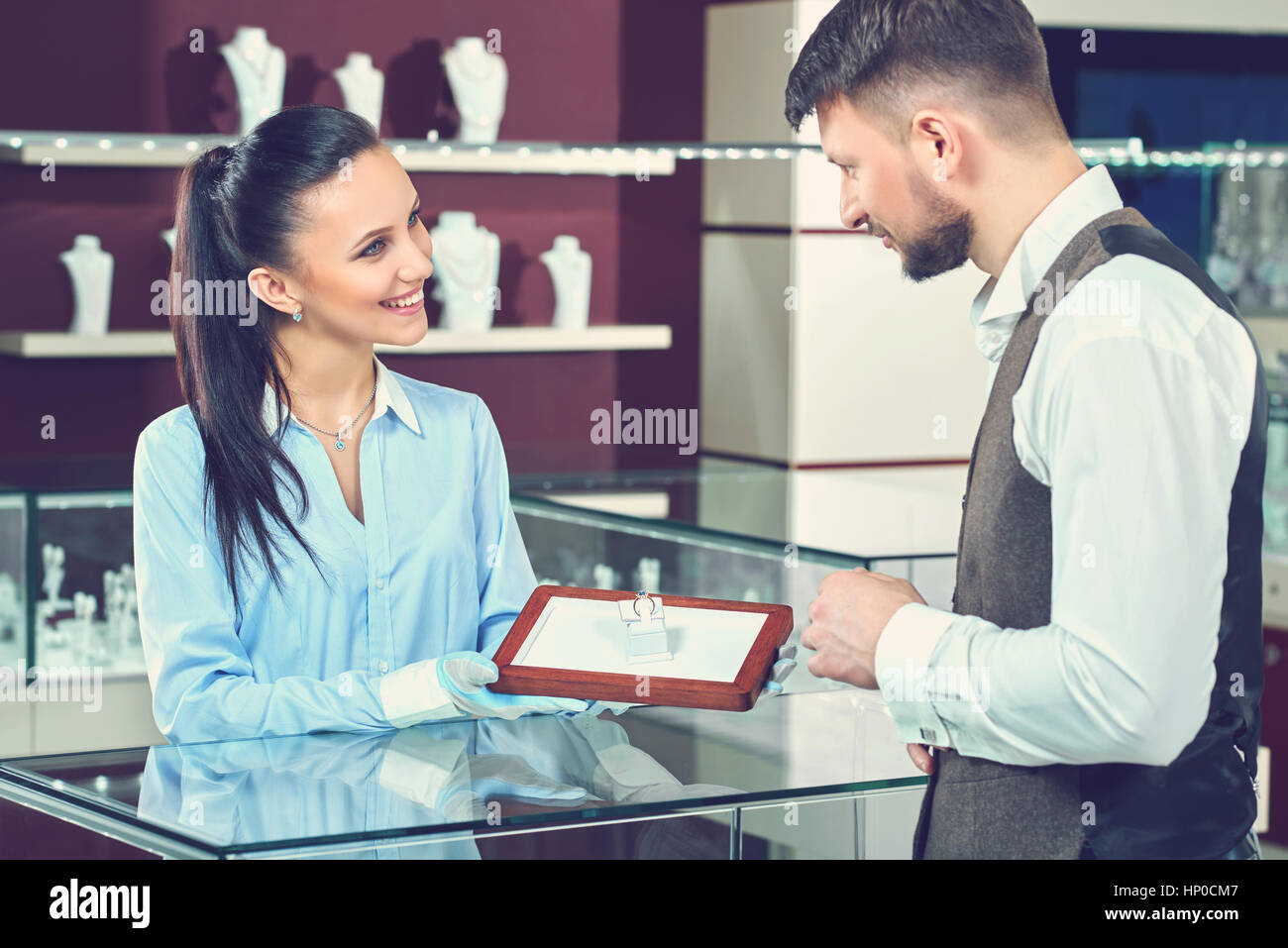 Handsome young man buying jewelry at the local jewelry store Stock