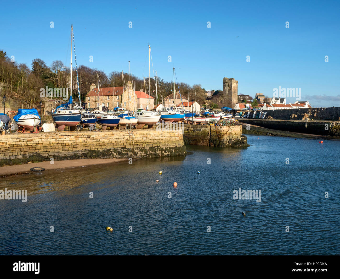 Boats on the quayside at the Dysart Harbour with the Harbour House and Sr Serfs Kirk behind Dysart Kirkcaldy Fife Scotland Stock Photo