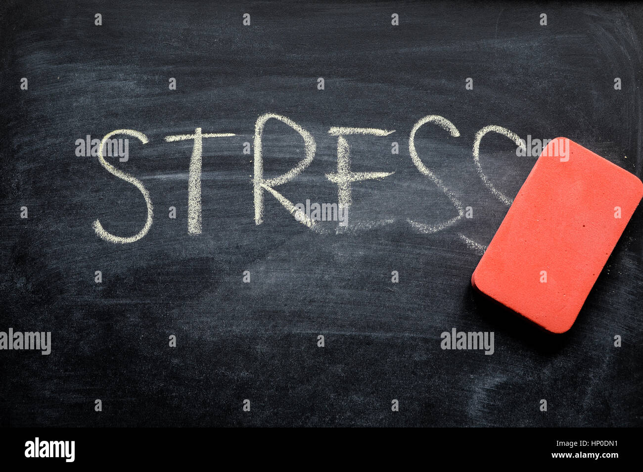 erasing stress, hand written word on blackboard being erased concept Stock Photo