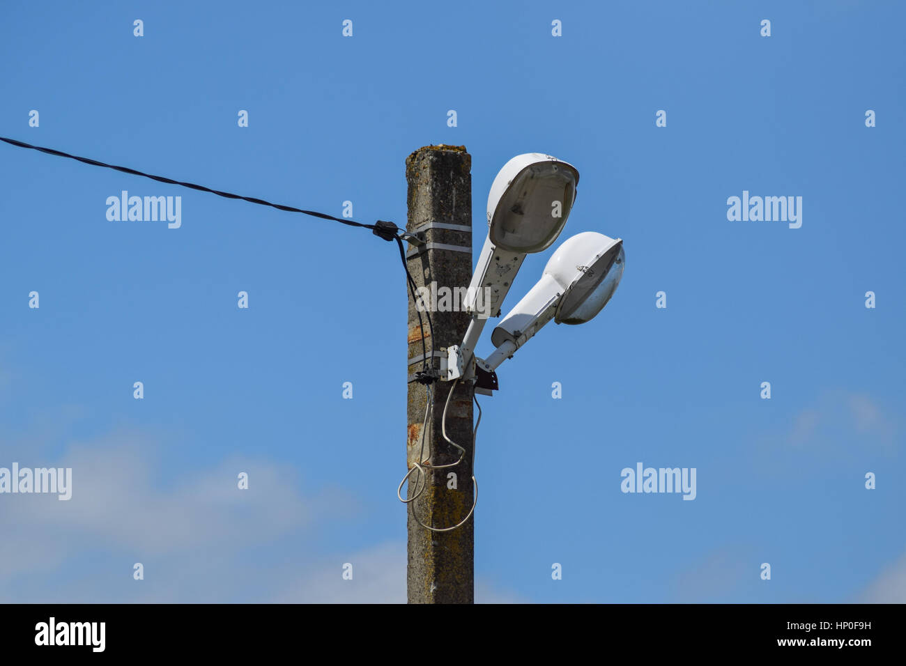 Lanterns on the pole. A pillar of power line with lighting fixtures. Stock Photo