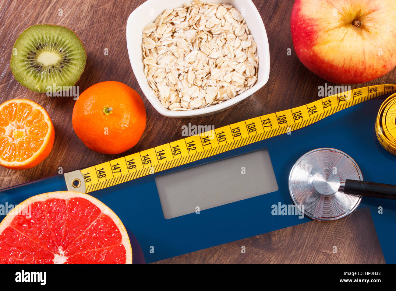 Measuring tape wrapped around bathroom scales. Concept of weight loss, diet,  healthy lifestyle., Stock image