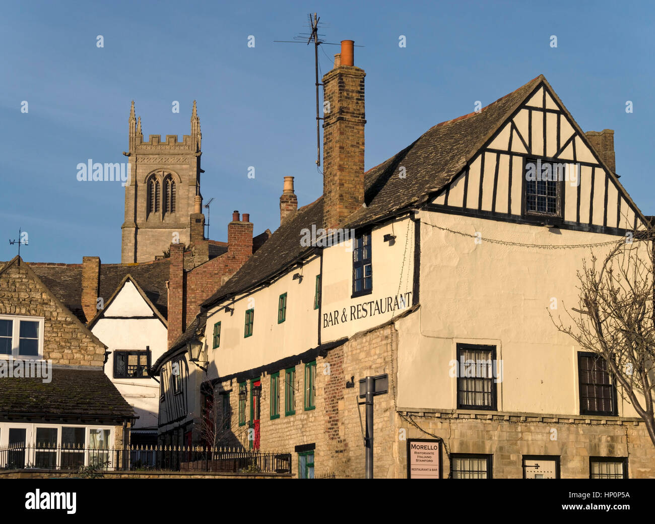 Morello Italian restaurant (now closed), old buildings and tower of St Johns Church, Stamford, Lincolnshire, England, UK Stock Photo