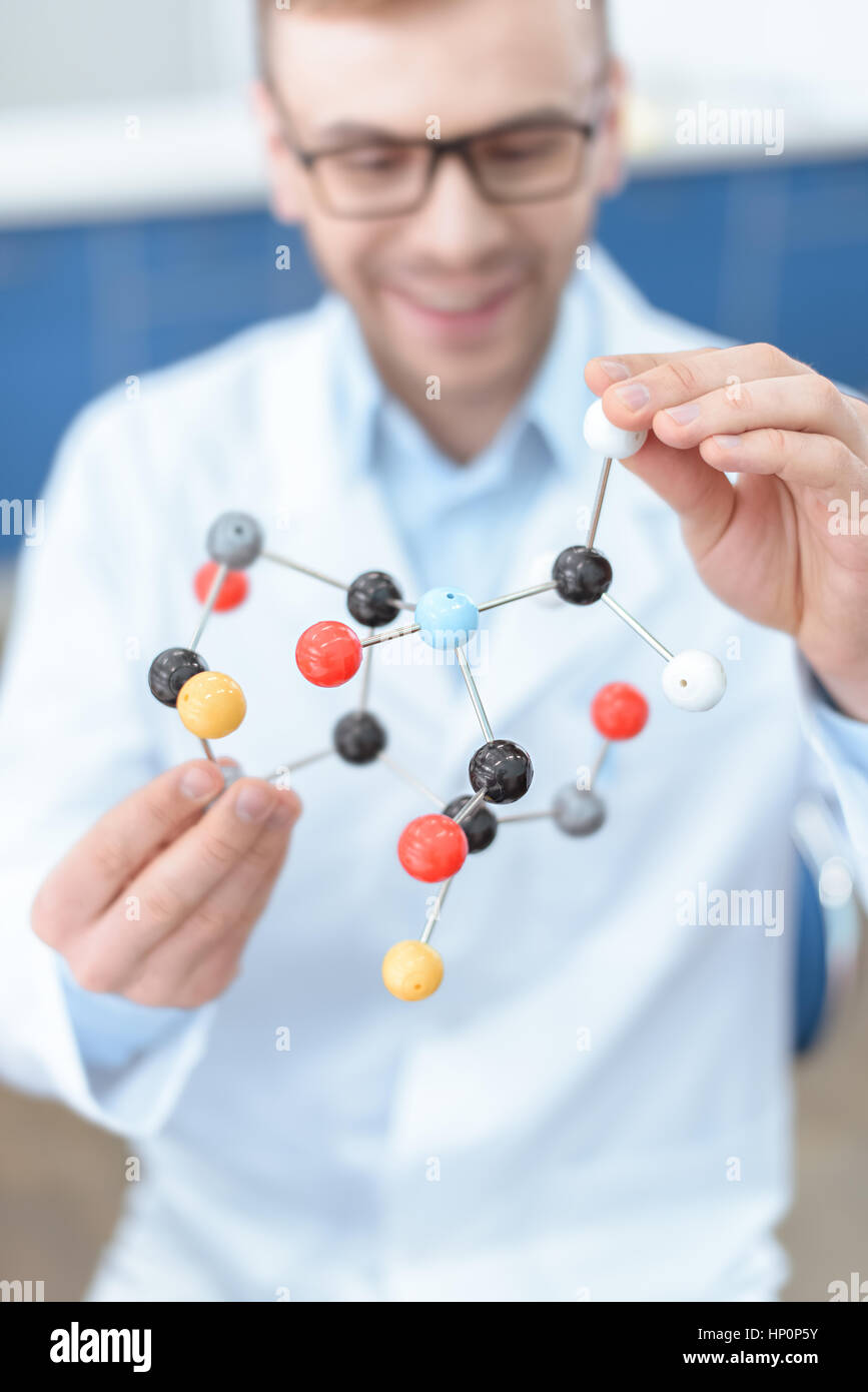 scientist in lab coat holding molecular model Stock Photo - Alamy