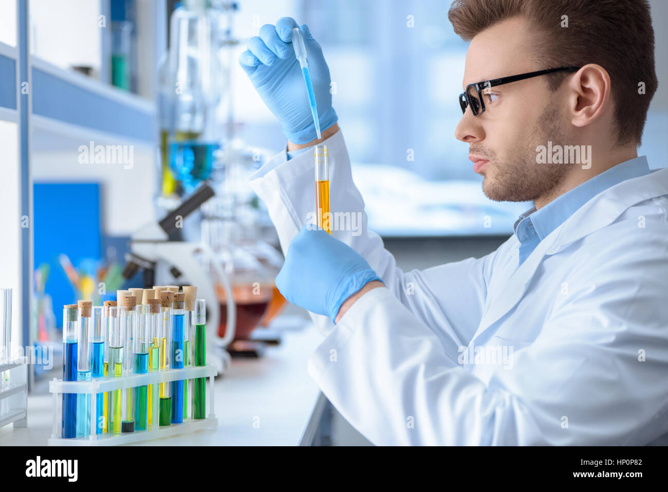 chemist making experiment in laboratory Stock Photo Alamy
