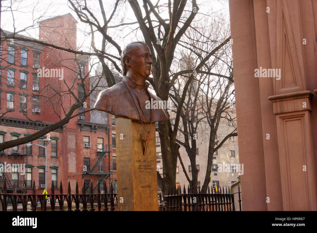 A bust of John Hughes, the first Archbishop of the Archdiocese of New York, stands outside Old St. Patrick’s Cathedral on Mott Street in Chinatown. Stock Photo