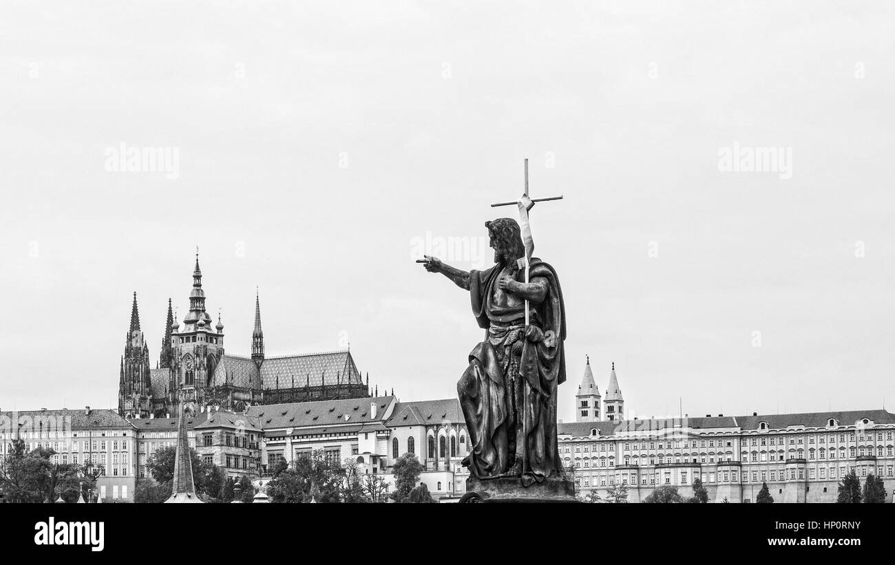 Cityscape of Prague in monochrome with statue of the Charles bridge in the foreground Stock Photo