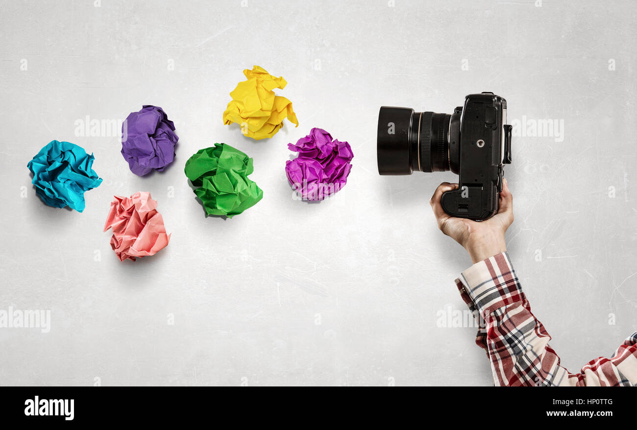 Close of woman hand in checked shirt holding photocamera Stock Photo
