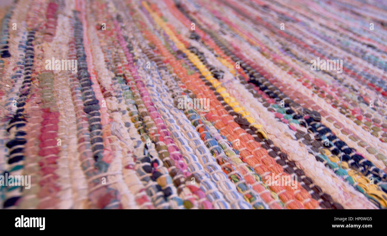 Colourful handmade patched rug on the floor,blurred in background ...