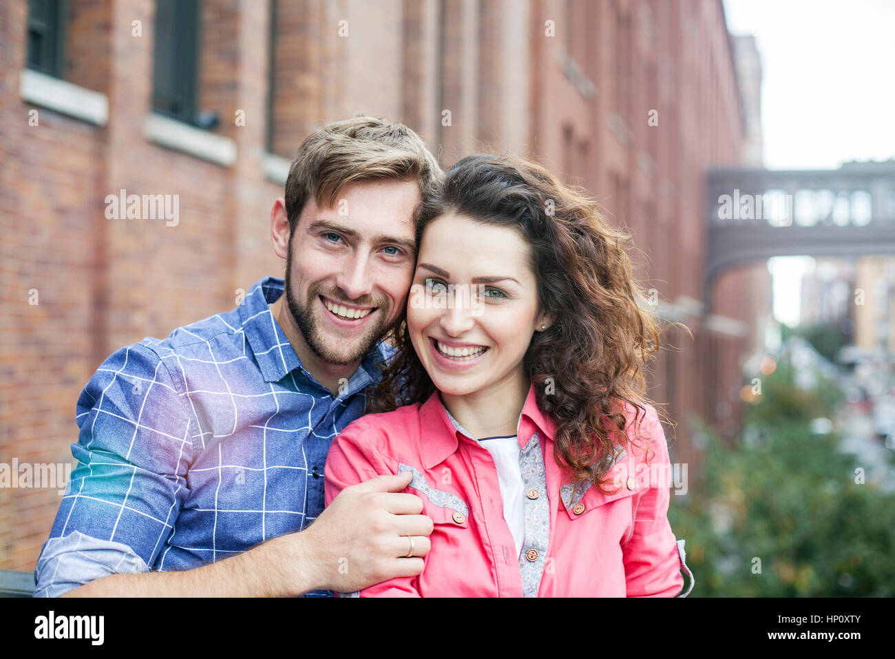 Couple smiling together outdoors, portrait Stock Photo
