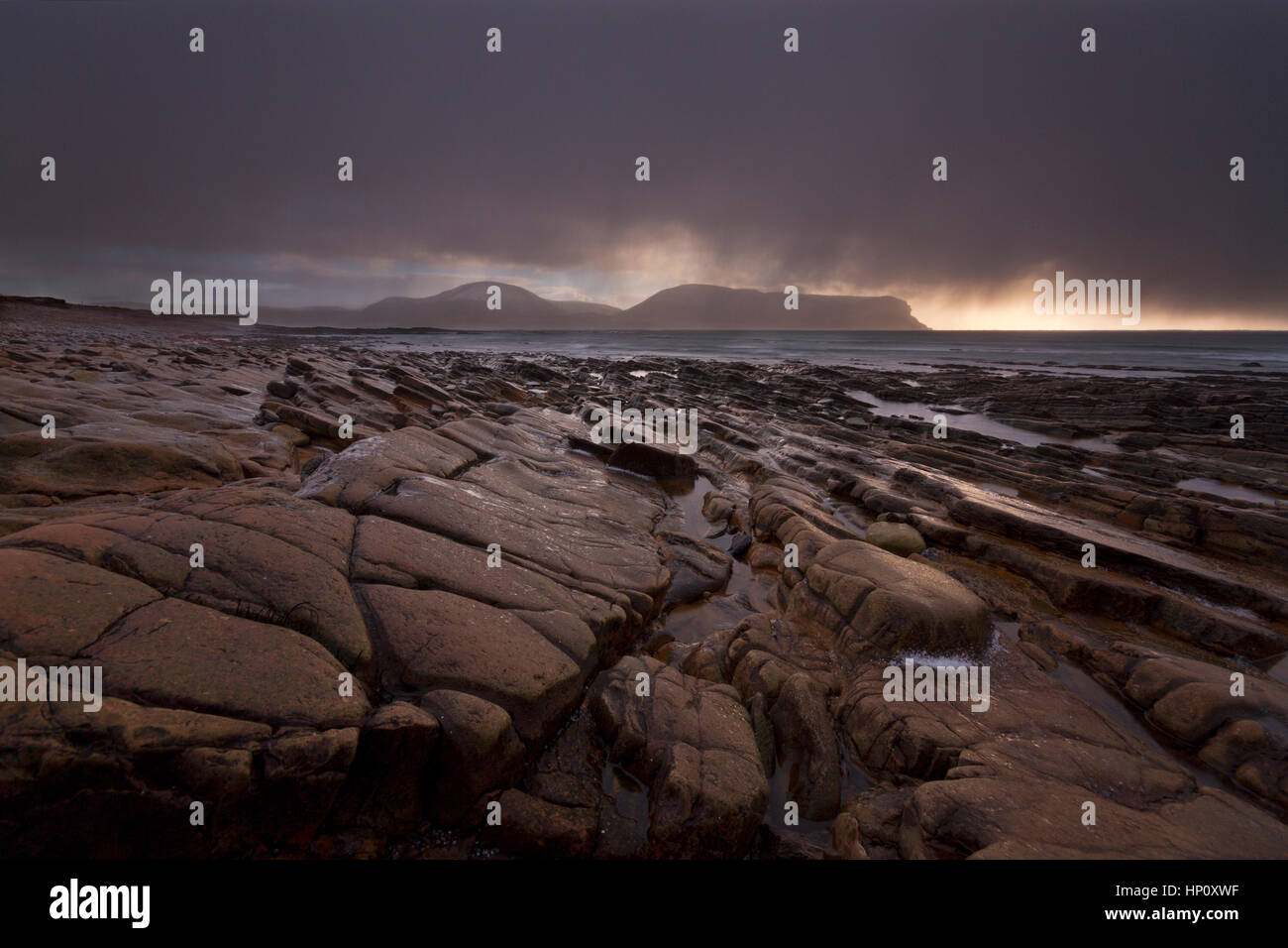 Rain and hail showers at Warebeth Rocky Beach on Orkney isles Stock Photo