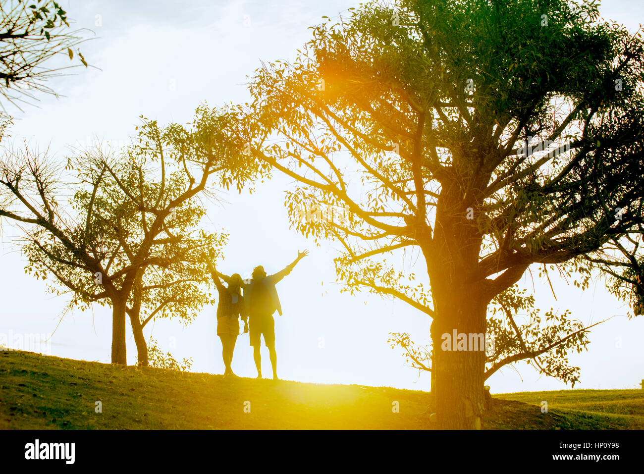 Couple enjoying nature, backlit by sunlight Stock Photo