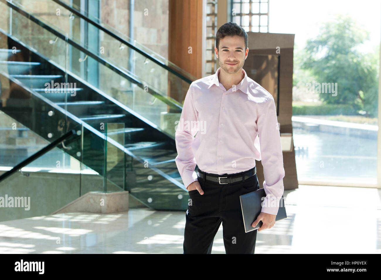 Young businessman standing in hotel lobby Stock Photo - Alamy