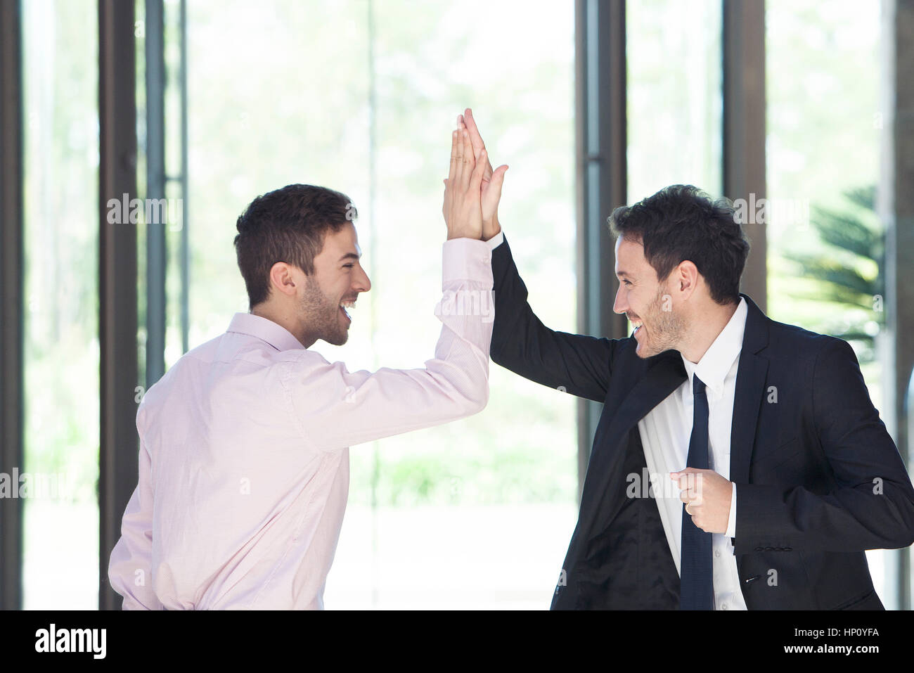 Businessmen congratulating each other with high-five Stock Photo