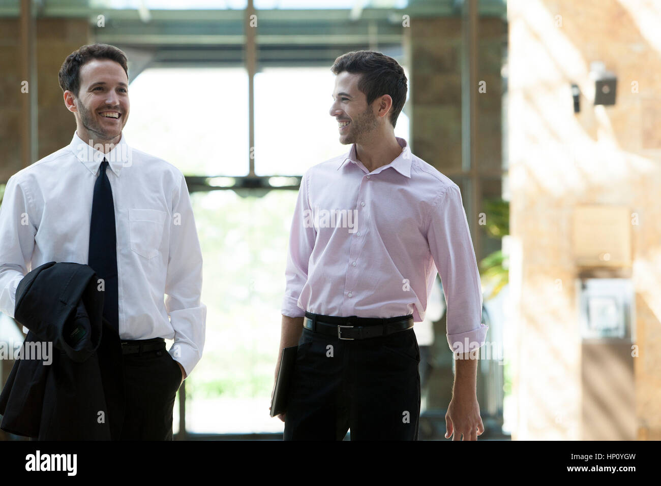 Two businessmen walking side by side hi-res stock photography and ...