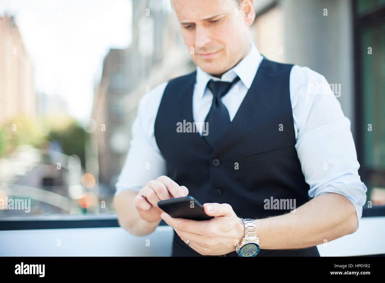 Businessman text messaging with smartphone Stock Photo