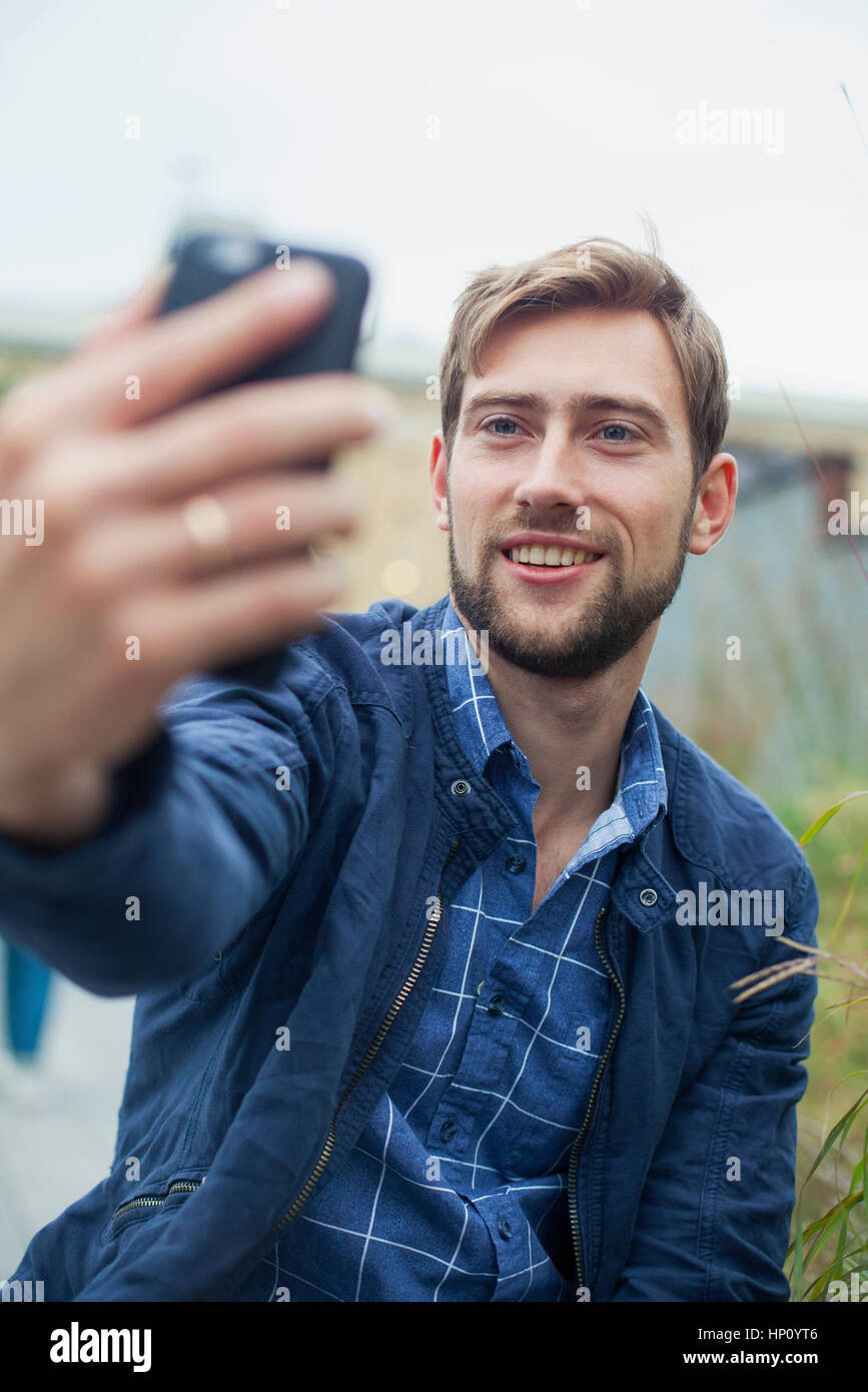 Man using smartphone to take a selfie Stock Photo
