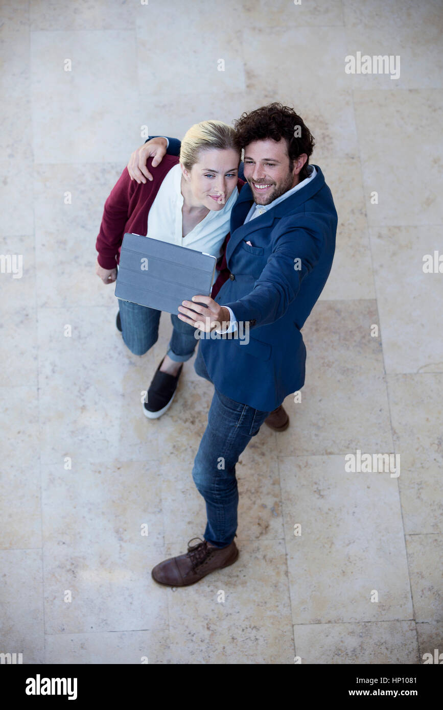 Couple using digital tablet to take a selfie Stock Photo