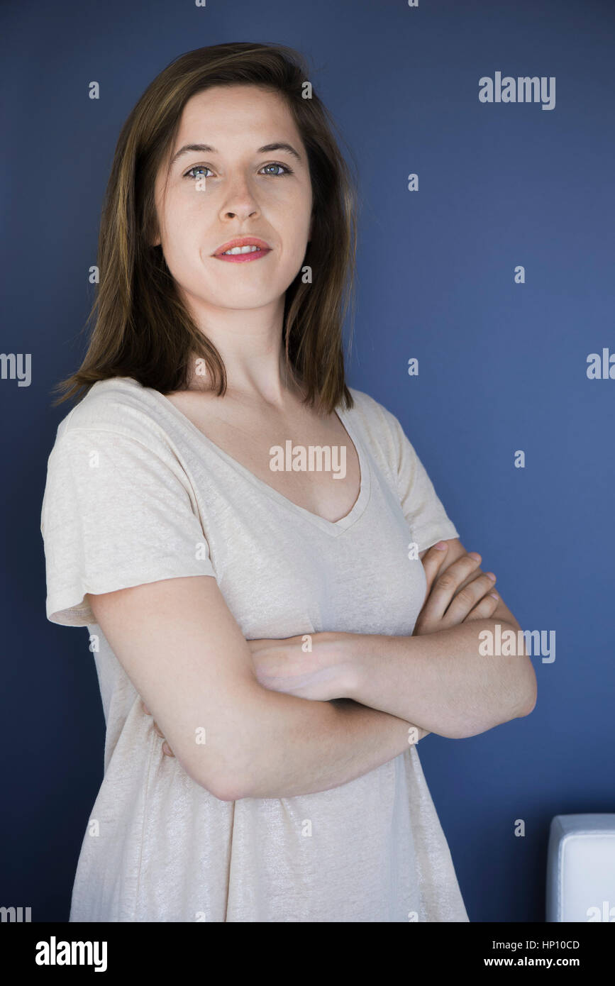 Woman with arms folded across chest, portrait Stock Photo Alamy