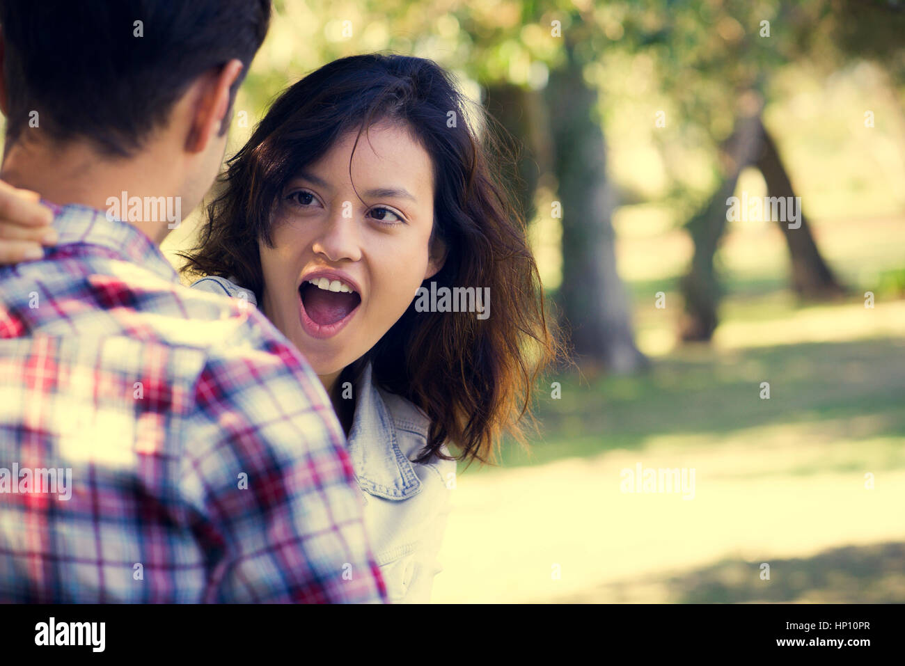 Young woman making face at boyfriend Stock Photo