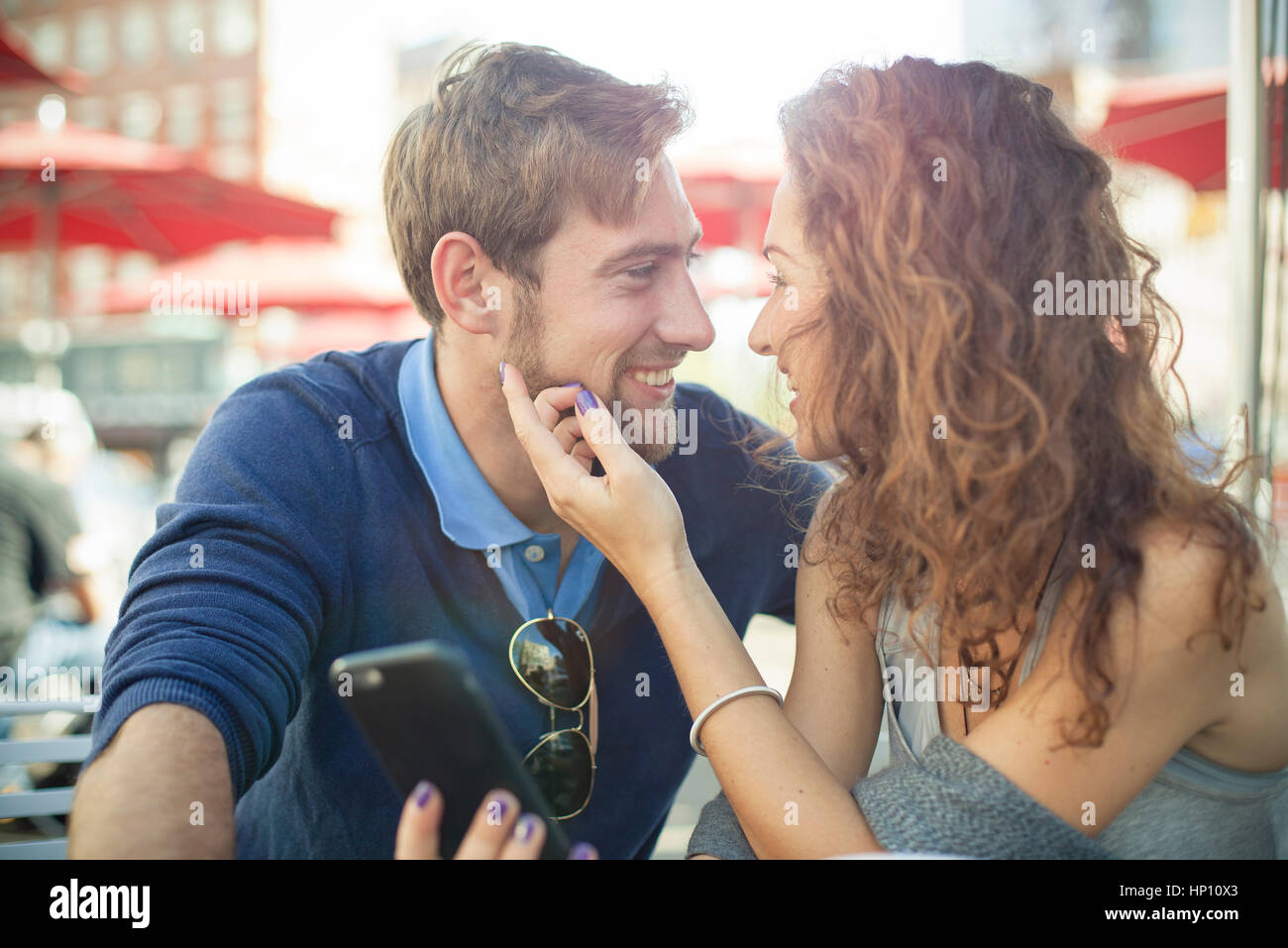 Affectionate couple sitting together outdoors Stock Photo