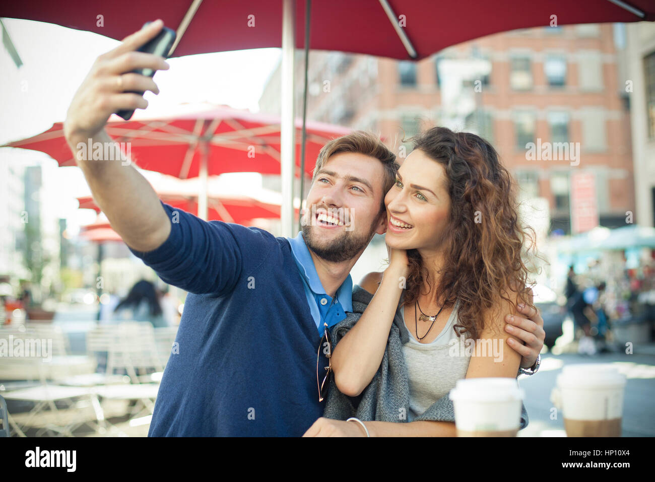 Couple posing for a selfie at outdoor cafe Stock Photo