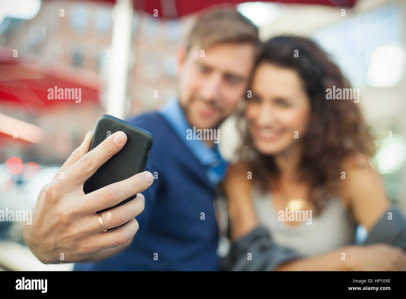 Man using smartphone to photgraph himself with his wife Stock Photo