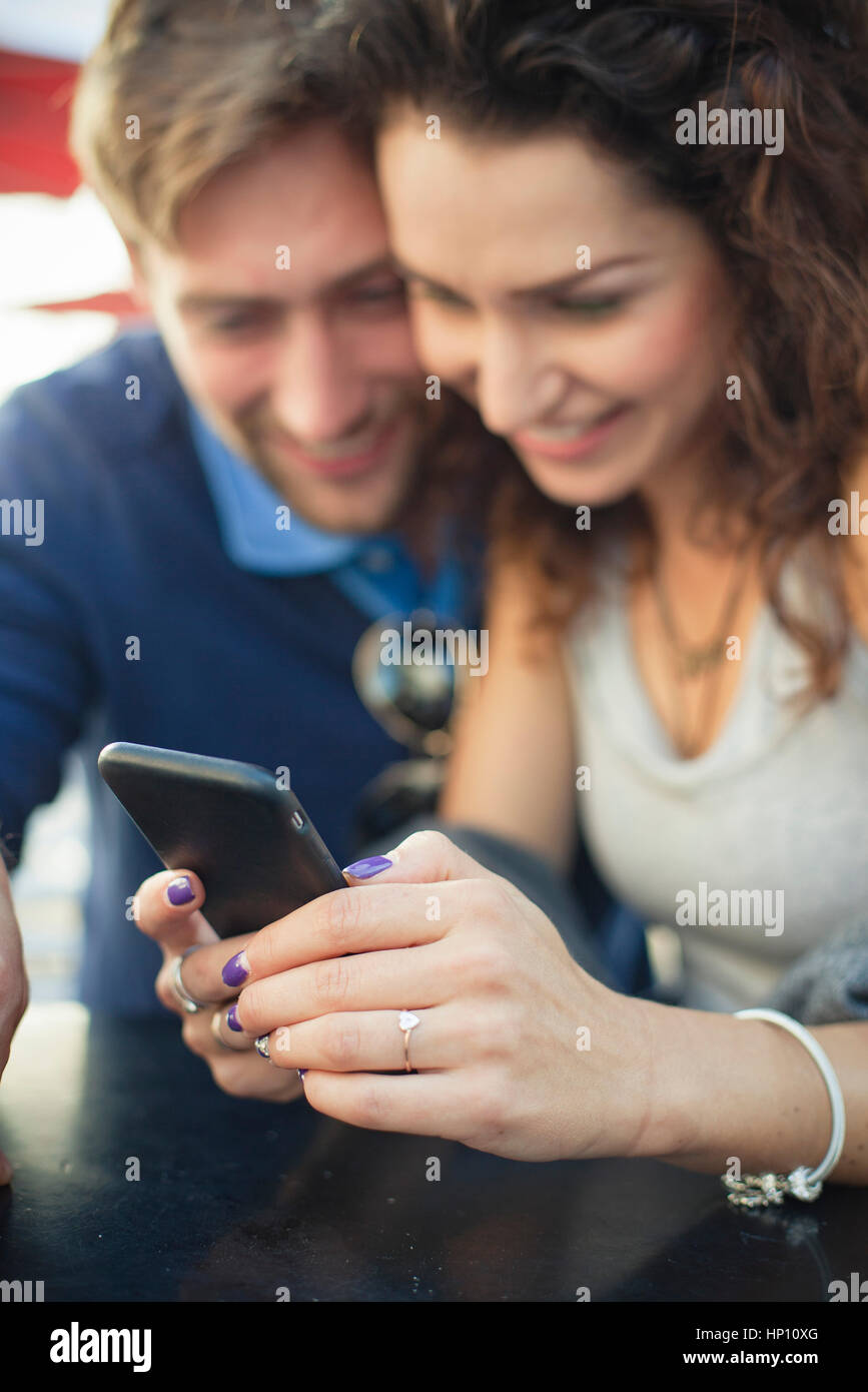 Couple looking at smartphone together Stock Photo