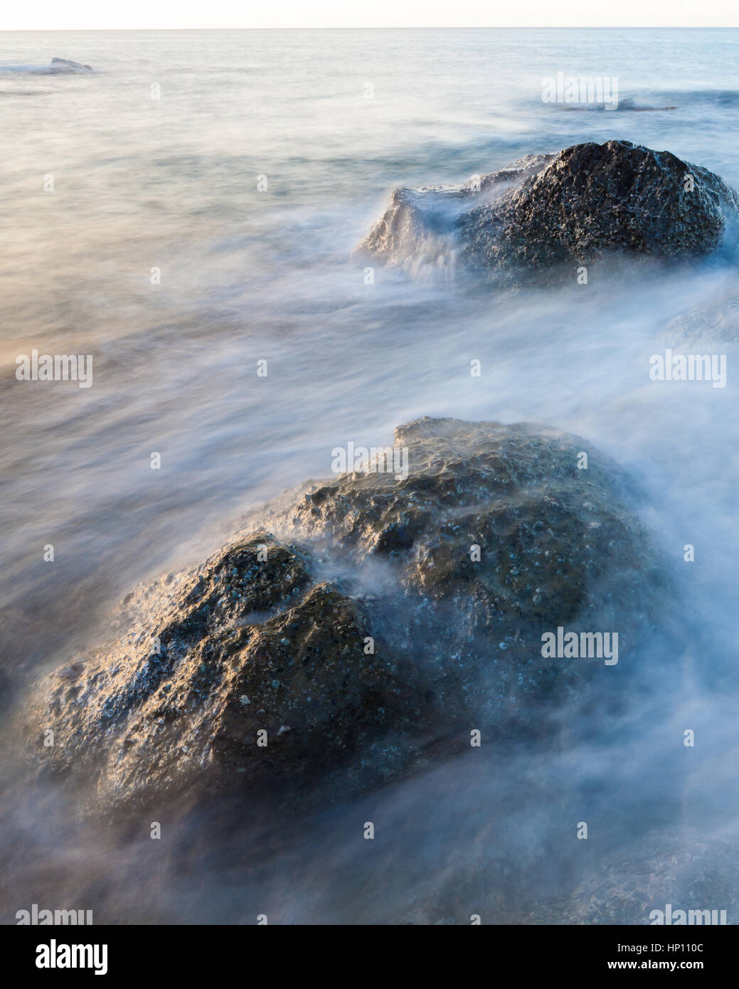 Waves and rocks shore long exposure Stock Photo - Alamy