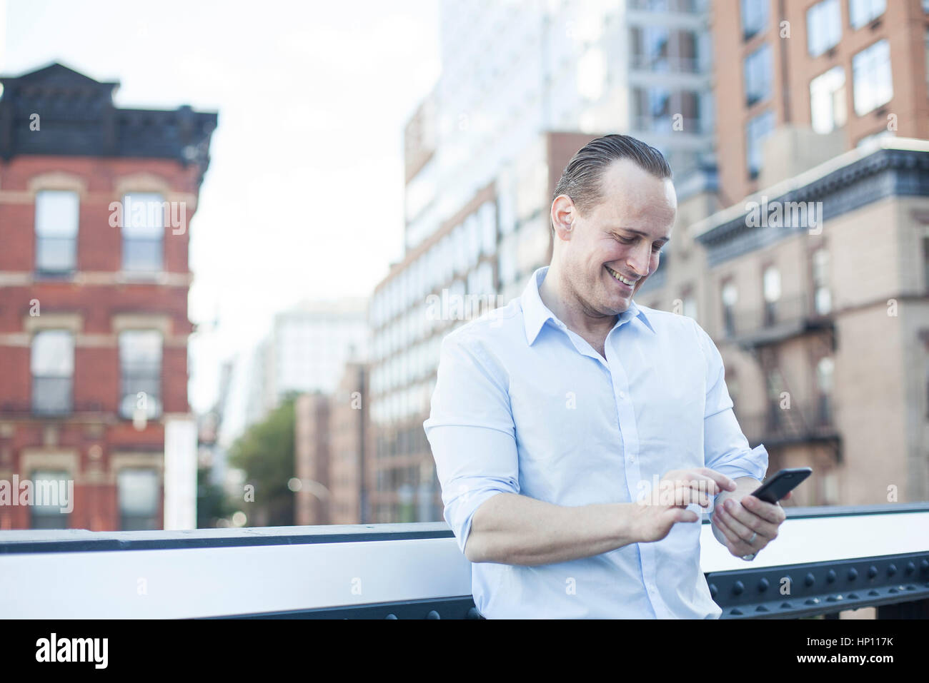 Man text messaging with smartphone Stock Photo
