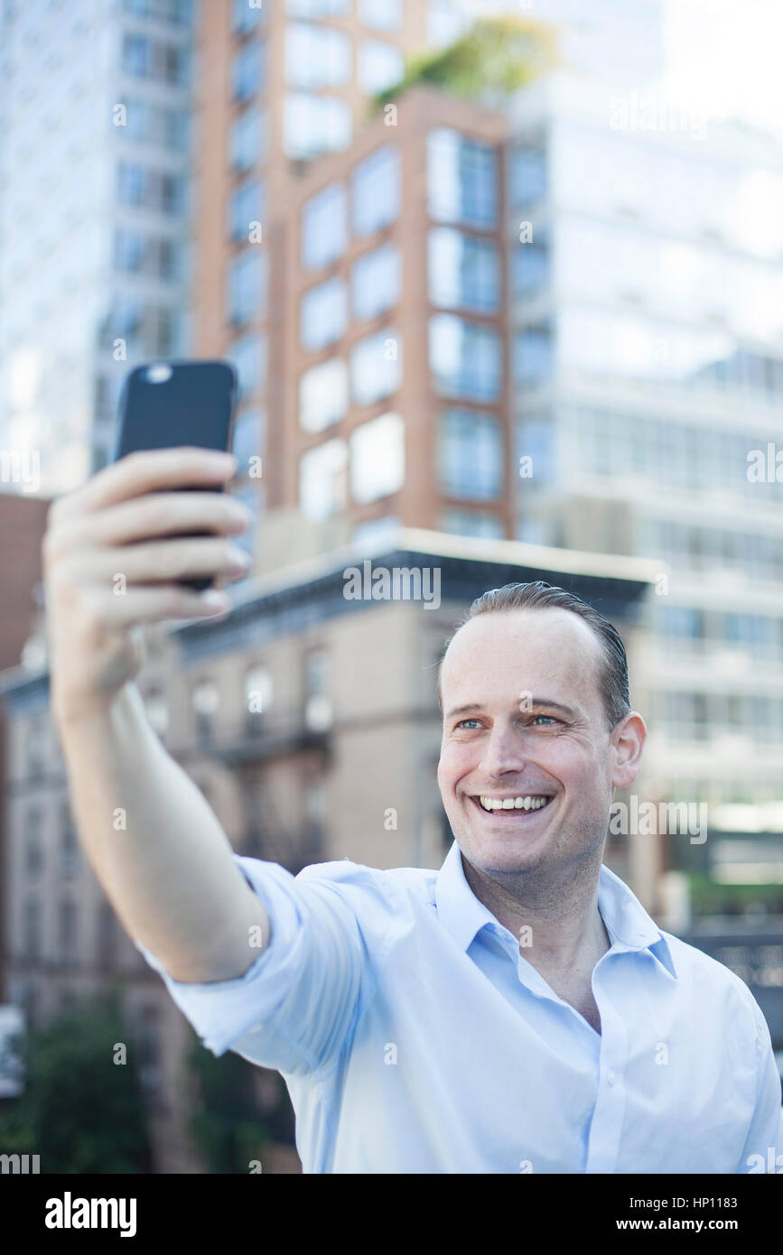 Man using smartphone to take a selfie Stock Photo