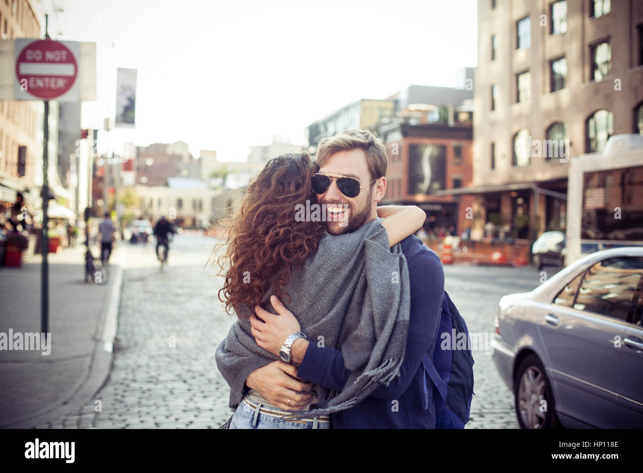 Couple embracing on city street Stock Photo