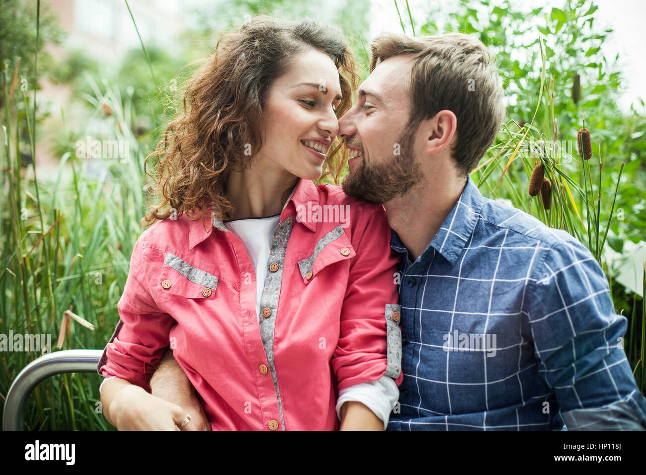Young couple nuzzling outdoors Stock Photo