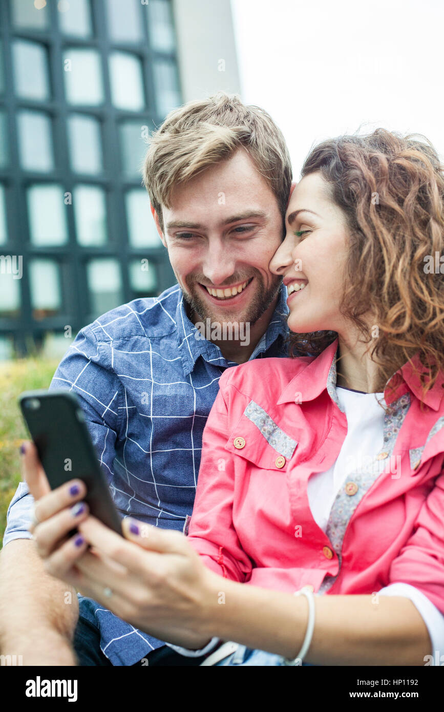 Couple using smartphone to take a selfie Stock Photo
