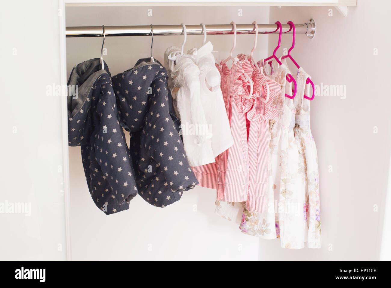 https://c8.alamy.com/comp/HP11CE/baby-clothes-hanging-in-closet-HP11CE.jpg