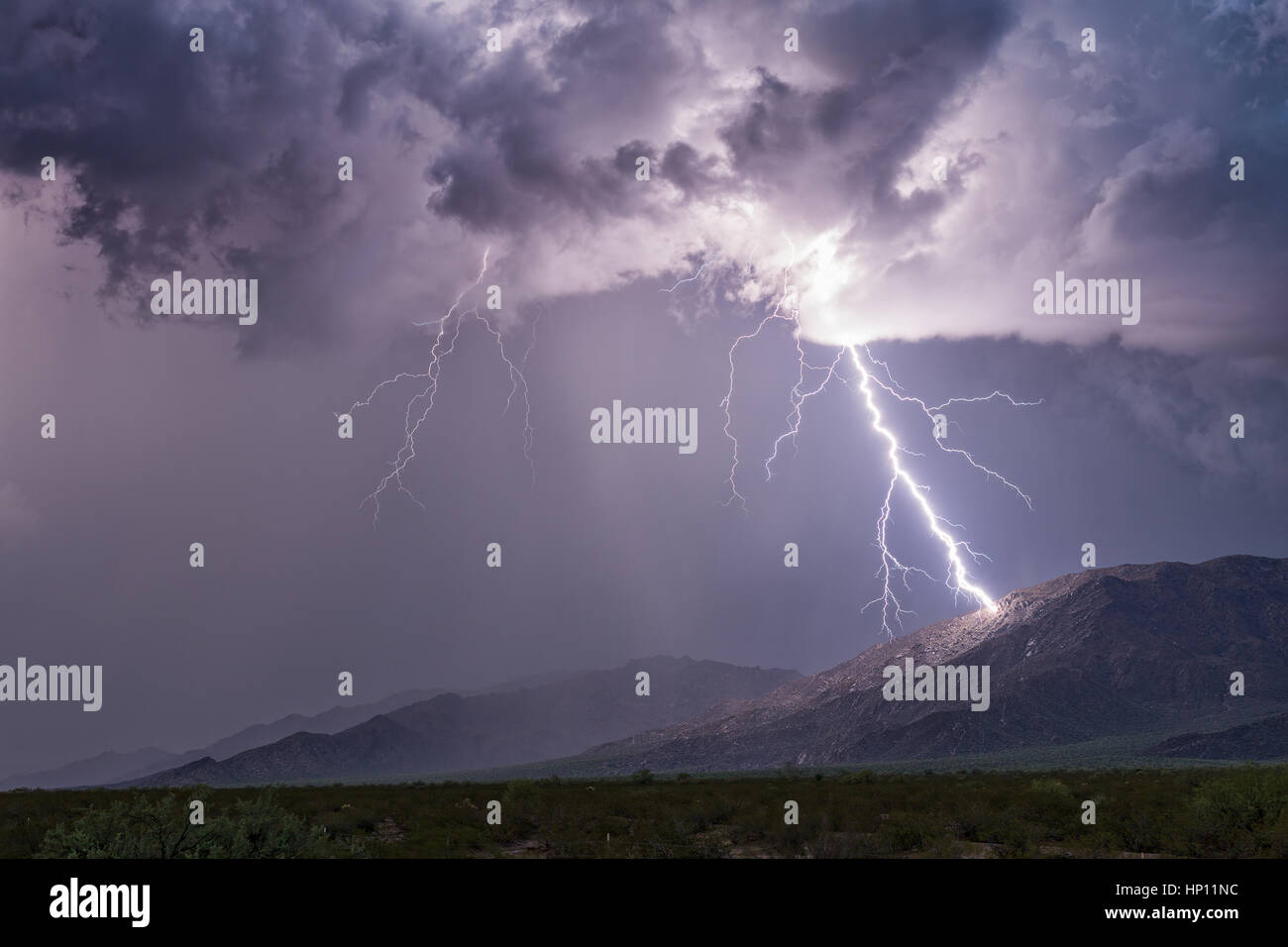 Lightning bolt striking a mountain in a storm near Aguila, Arizona Stock Photo