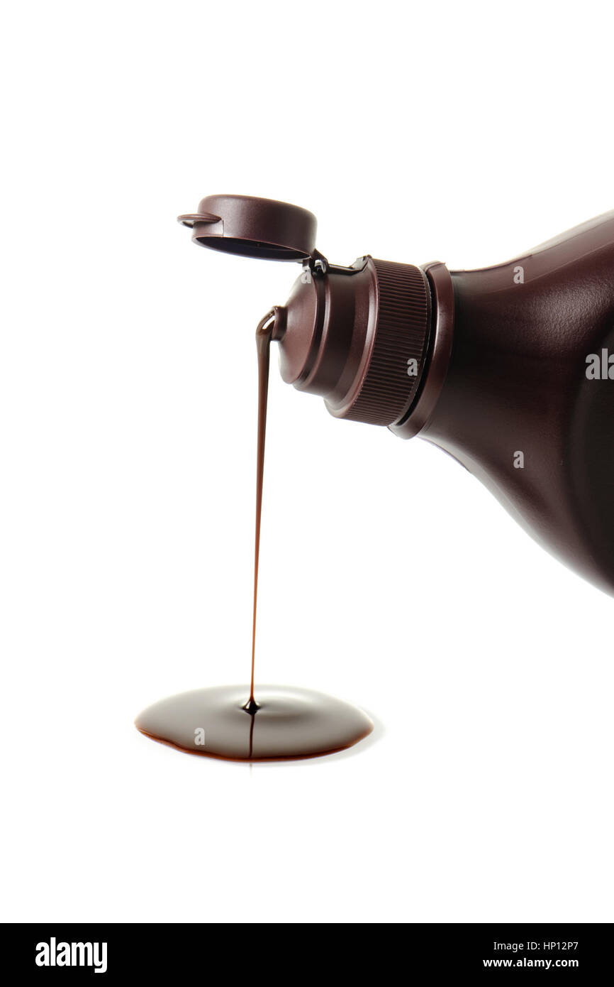closeup chocolate syrup pouring on white background Stock Photo Alamy
