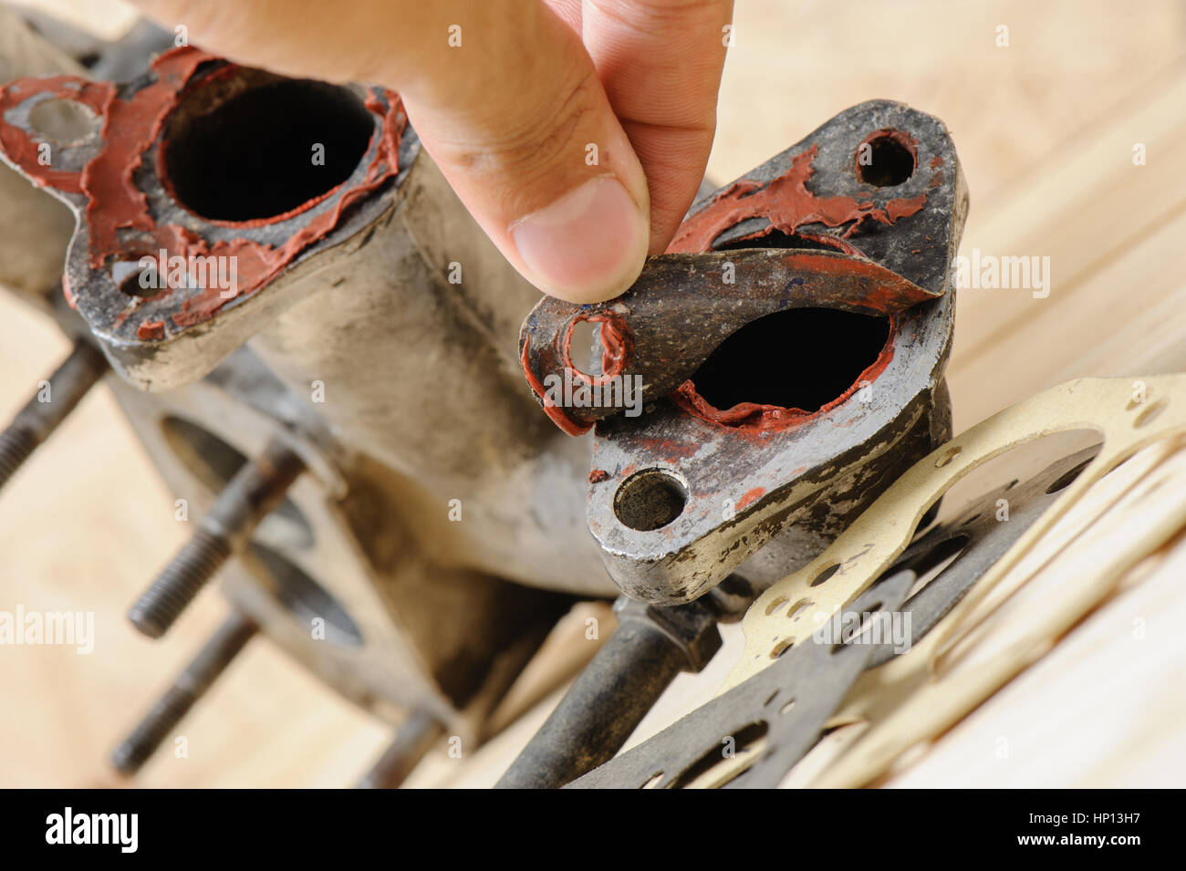 removing old gasket from intake manifolds holes Stock Photo Alamy