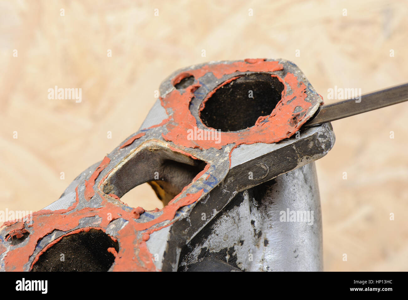 removing old gasket from intake manifolds holes Stock Photo Alamy