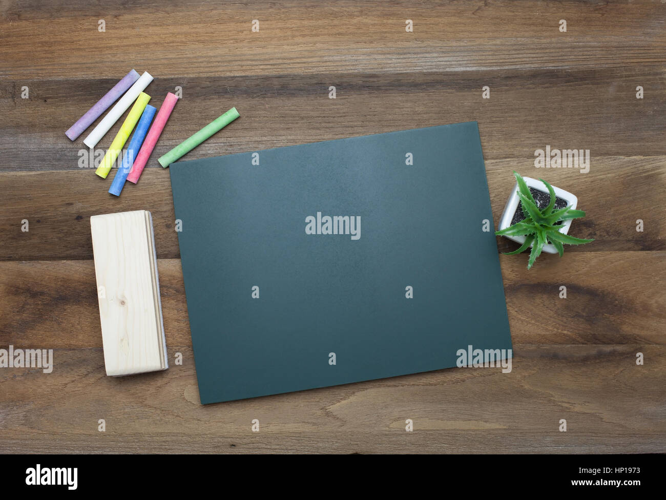 Colorful Chalks,Chalk board and eraser on wooden background Stock Photo